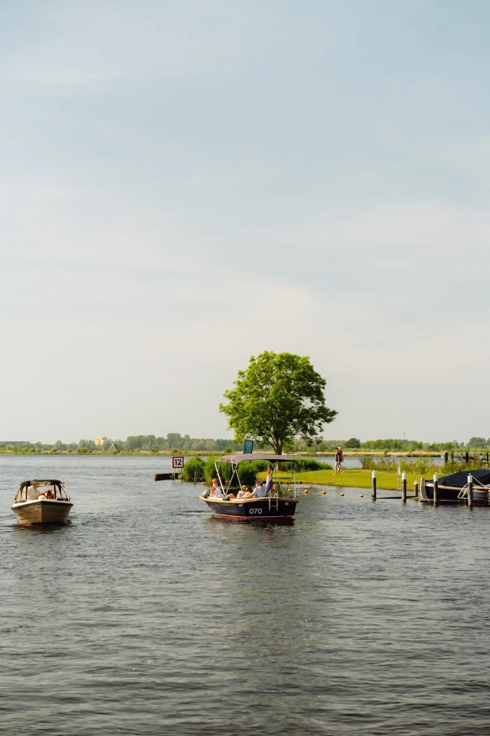 Boats on calm water under a wide Dutch sky