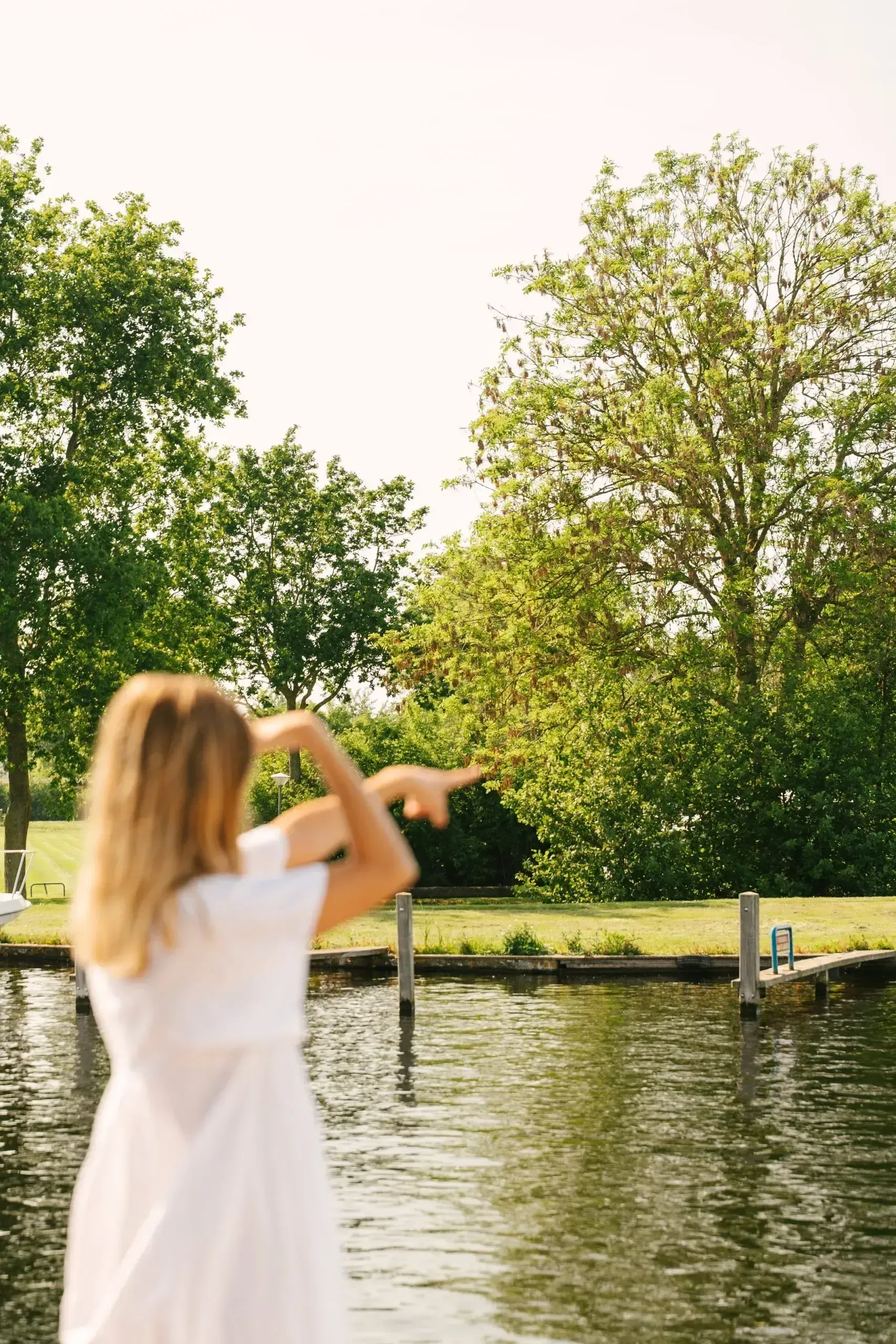 A guest standing by the water in the late sun