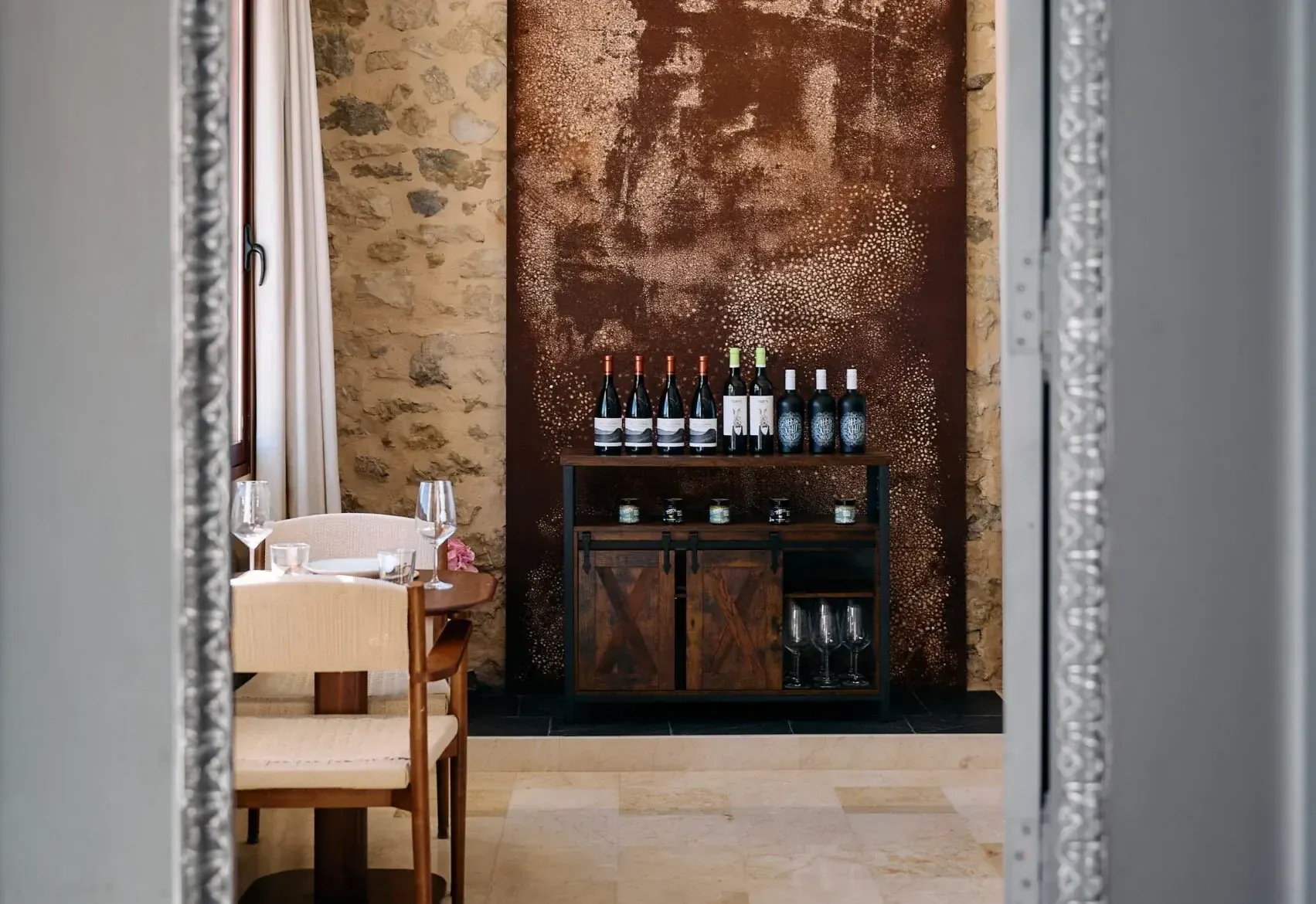 A doorway opening onto the dining room and the wine wall