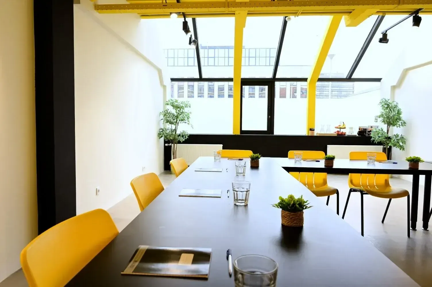 The bright yellow co-working area of YOUNG Learning Hotel