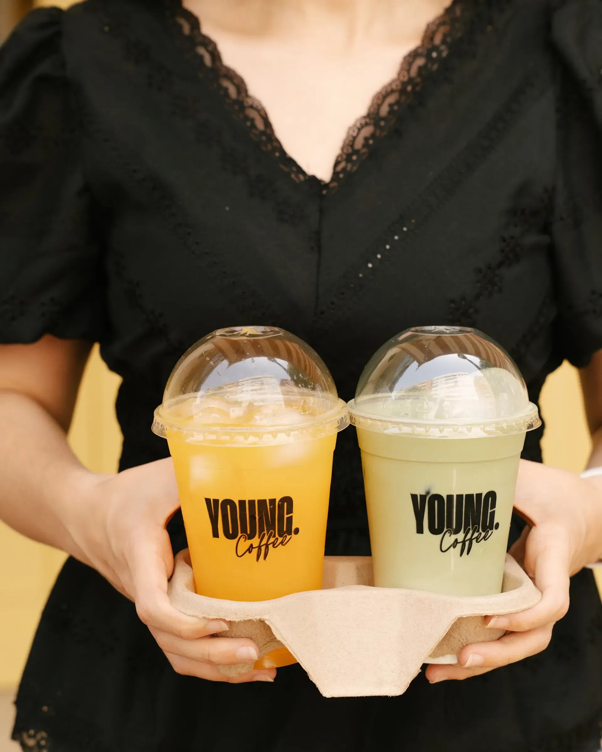 Two YOUNG Coffee drinks carried in a tray