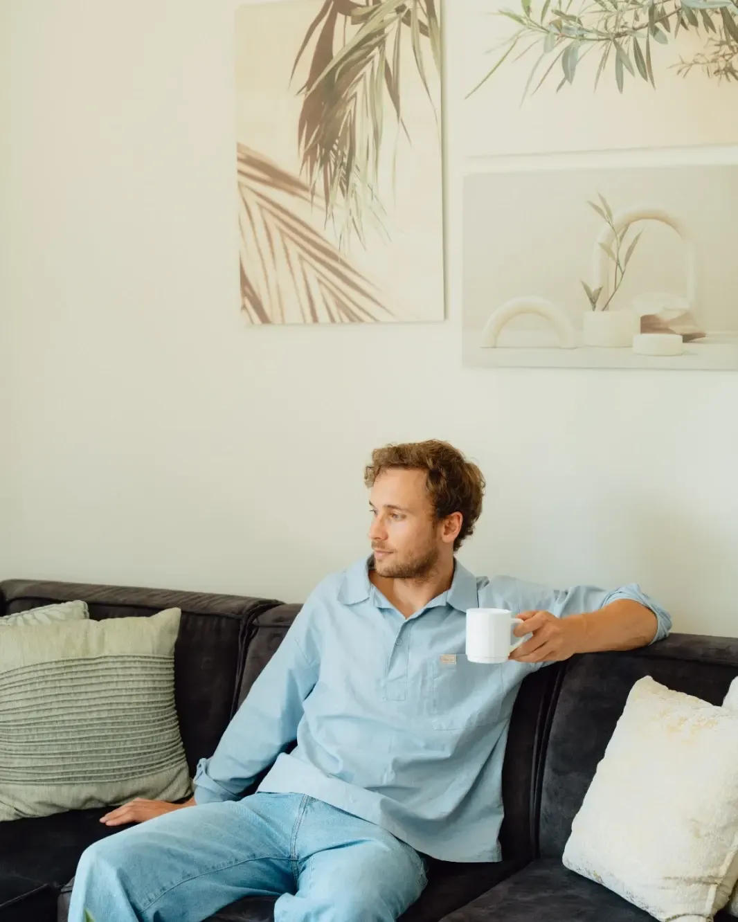 A guest with a coffee on the sofa in the morning